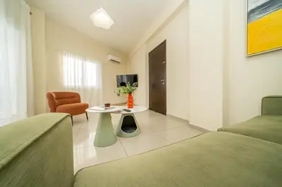 a hotel room with two beds and a table at 2 bedroom flat in Nicosia
