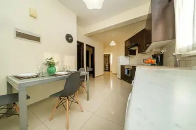 a kitchen with a table and chairs in a room at 2 bedroom flat in Nicosia