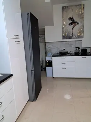 a kitchen with white counters and white appliances at ANDRIA'S luxury family studio near Casino limassol in Limassol
