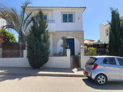 a silver car parked in front of a white house at MANDARIN Villa in Paralimni