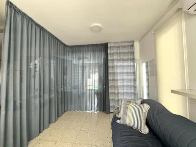 a living room with a couch and a large window at STAY ALKYONI Villa in Protaras