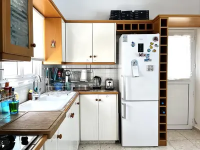 a kitchen with white cabinets and a white refrigerator at STAY ALKYONI Villa in Protaras