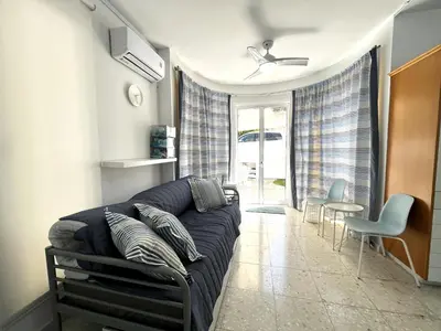 a living room with a couch and a table and chairs at STAY ALKYONI Villa in Protaras