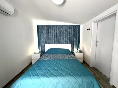 a bedroom with a bed with a blue comforter at STAY ALKYONI Villa in Protaras