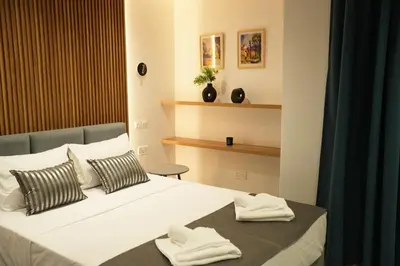 a bedroom with a bed with two towels on it at Zen City Suites in Larnaka
