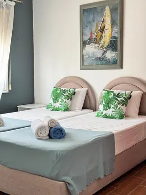 two beds sitting next to each other in a bedroom at Gold Feather 2Bedroom Center Location and Pool in Ayia Napa