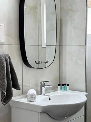 a bathroom with a sink and a mirror at Gold Feather 2Bedroom Center Location and Pool in Ayia Napa