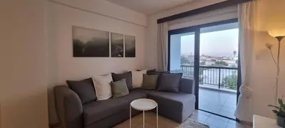 a living room with a couch and a balcony at The Cozy Home Stay in Larnaca in Larnaka