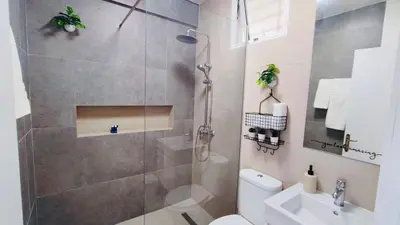 a bathroom with a shower and a toilet and a sink at Sunny Days Apartment in Paralimni