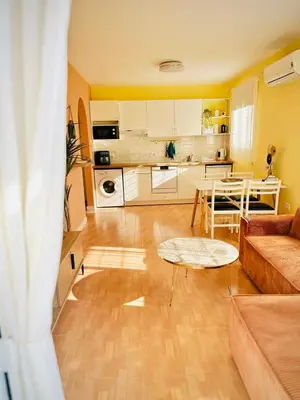 a living room with a couch and a table at Sunny Days Apartment in Paralimni