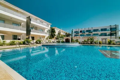 a large swimming pool in front of a building at Mythical Sands Resort and Spa in Paralimni