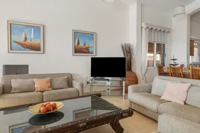 a living room with a couch and a coffee table at Villa Thea, Luxury Cliff Sea View in Pissouri