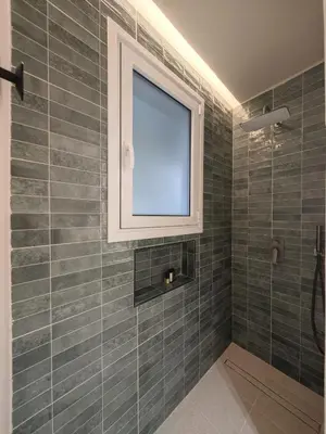 a bathroom with a window and a shower at Ficus Suite 001 in Voroklini