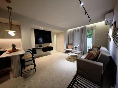 a living room with a couch and a table at Ficus Suite 001 in Voroklini