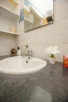 a white sink in a bathroom with a mirror at STAY Villa Kangaroo in Protaras