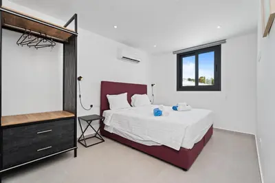 a bedroom with a bed and a window at PANATHEON - Luxury 1 & 2 bdr bungalows 300 meters from sandy beach! in Ayia Napa