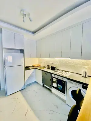a white kitchen with a stove and a refrigerator at Caesar Resort Apartments Marcellus 51 in Iskele