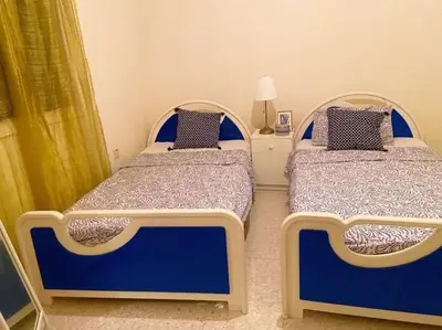two beds in a bedroom with blue and white at Holiday home in Kapparis in Paralimni