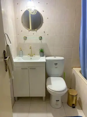 a bathroom with a toilet and a sink and a mirror at Holiday home in Kapparis in Paralimni