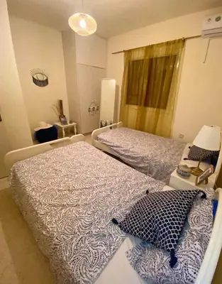 a bedroom with two beds and a lamp in it at Holiday home in Kapparis in Paralimni