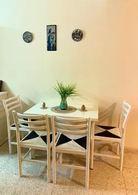 a dining room table and chairs with a plant on it at Holiday home in Kapparis in Paralimni