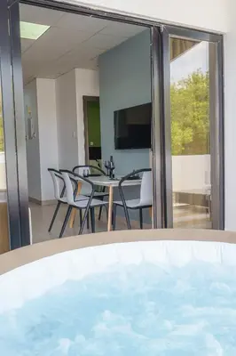 a view of a dining room with a table and chairs at Pernera One Suites in Pernera Protaras in Paralimni