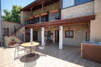 a patio with a table and chairs in front of a building at Archontikon 1817 in Kaliana