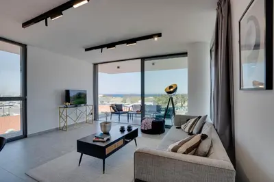 a living room with a couch and a table at Sea View Central Deluxe GAIA 302 in Larnaka
