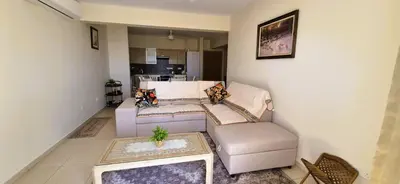 a living room with a couch and a table at Pyla Village Resort - F302 in Pyla