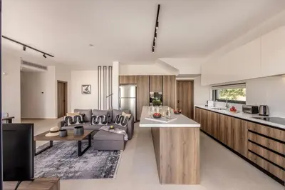 a kitchen and living room with a couch and a table at Villa Nissi 1 in Ayia Napa