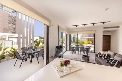 an open living room and dining room with sliding glass doors at Villa Nissi 1 in Ayia Napa