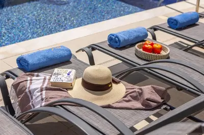 a hat sitting on a table near a pool at Villa Nissi 1 in Ayia Napa