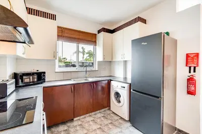 a kitchen with a refrigerator and a washer and dryer at Casa Giovanni By Ezoria Villas in Ayia Napa