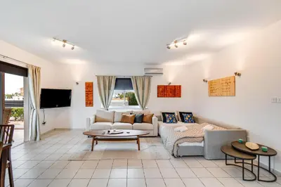 a living room with a couch and a table at Casa Giovanni By Ezoria Villas in Ayia Napa