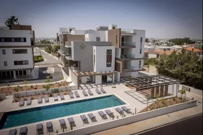 an aerial view of a building with a swimming pool at Kalamon Luxury Suite 203 w Pool and Gym in Livadhia