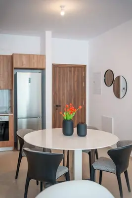 a dining room with a table and chairs at Kalamon Luxury Suite 105 w Pool & Gym in Livadhia