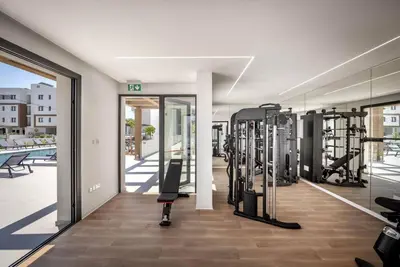 a fitness room with a lot of exercise equipment at Kalamon Luxury Suite 105 w Pool & Gym in Livadhia