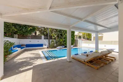 a swimming pool with a white pergola and a swimming pool at Protaras Utopia in Protaras