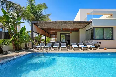 a house with a swimming pool next to a house at Villa Evergreen - 3bed Bungalow large pool in Protaras