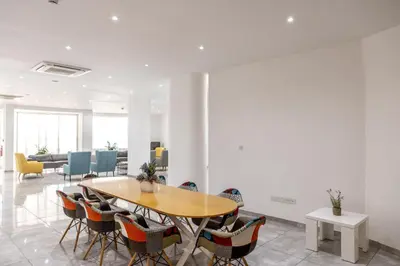 a conference room with a wooden table and chairs at Papantonia Hotel in Protaras
