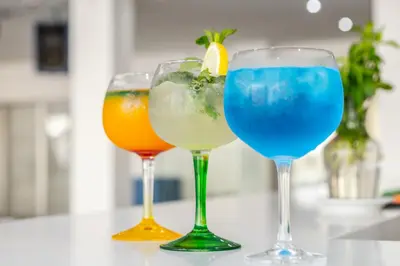 three wine glasses with different types of drinks at Papantonia Hotel in Protaras