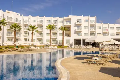 a hotel with a swimming pool in front of a building at Papantonia Hotel in Protaras