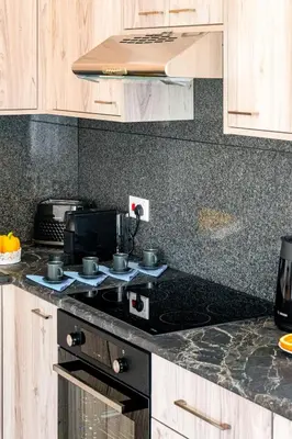 a kitchen with a stove top oven in a kitchen at Aeolis Court Apartment by Ezoria Villas in Limassol