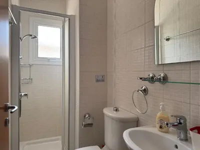 a bathroom with a toilet and a sink and a shower at Sunset Villa Agia Thekla in Ayia Napa
