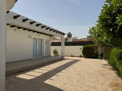 a white house with a porch and a patio at Sunset Villa Agia Thekla in Ayia Napa