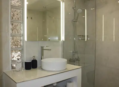 a bathroom with a sink and a shower at Nicosia Central Suites in Nicosia