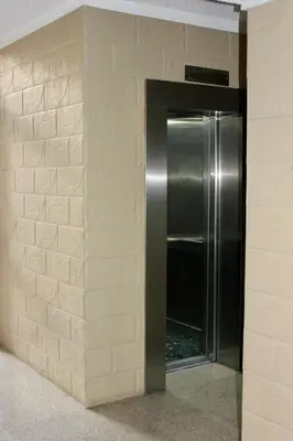 a stainless steel refrigerator in a brick wall at Nicosia Central Suites in Nicosia