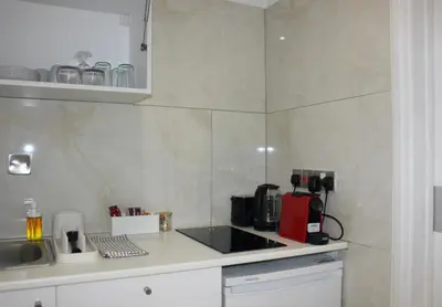 a kitchen with a counter top with a coffee maker at Nicosia Central Suites in Nicosia