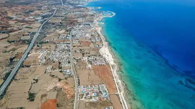 an aerial view of a beach next to the ocean at La Casa De Louie in Ayia Napa
