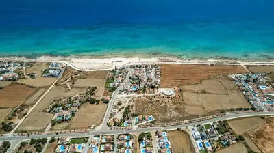 an aerial view of a parking lot next to the ocean at La Casa De Louie in Ayia Napa